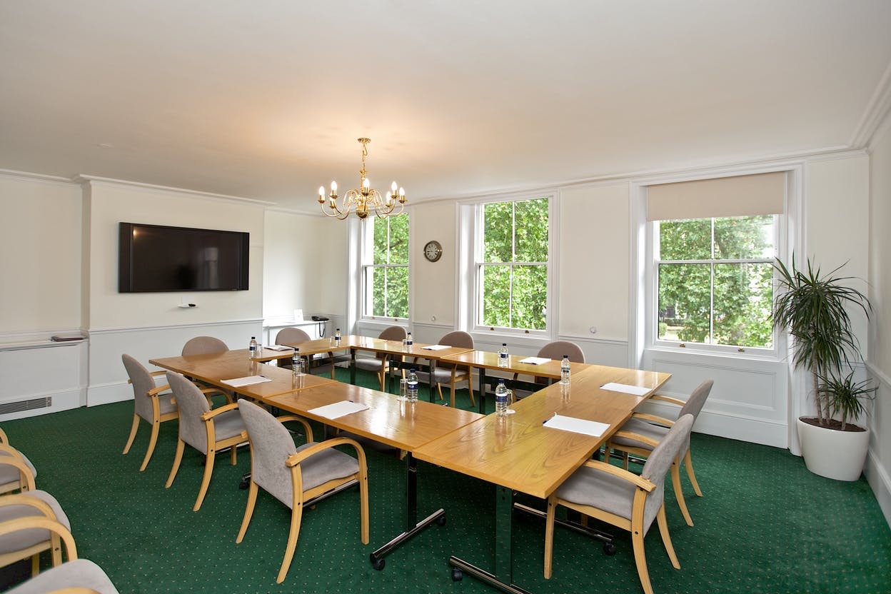 Saxon Sydney-Turner Room with wooden table, ideal for meetings and events.