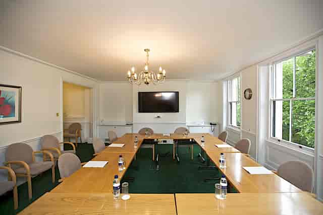 Saxon Sydney-Turner Room: bright meeting space with long table for professional events.