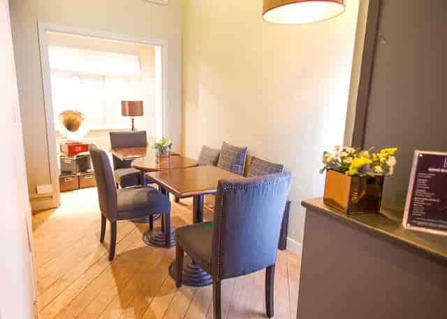 Clubhouse breakout room with plush seating for small-group strategy meetings and networking.