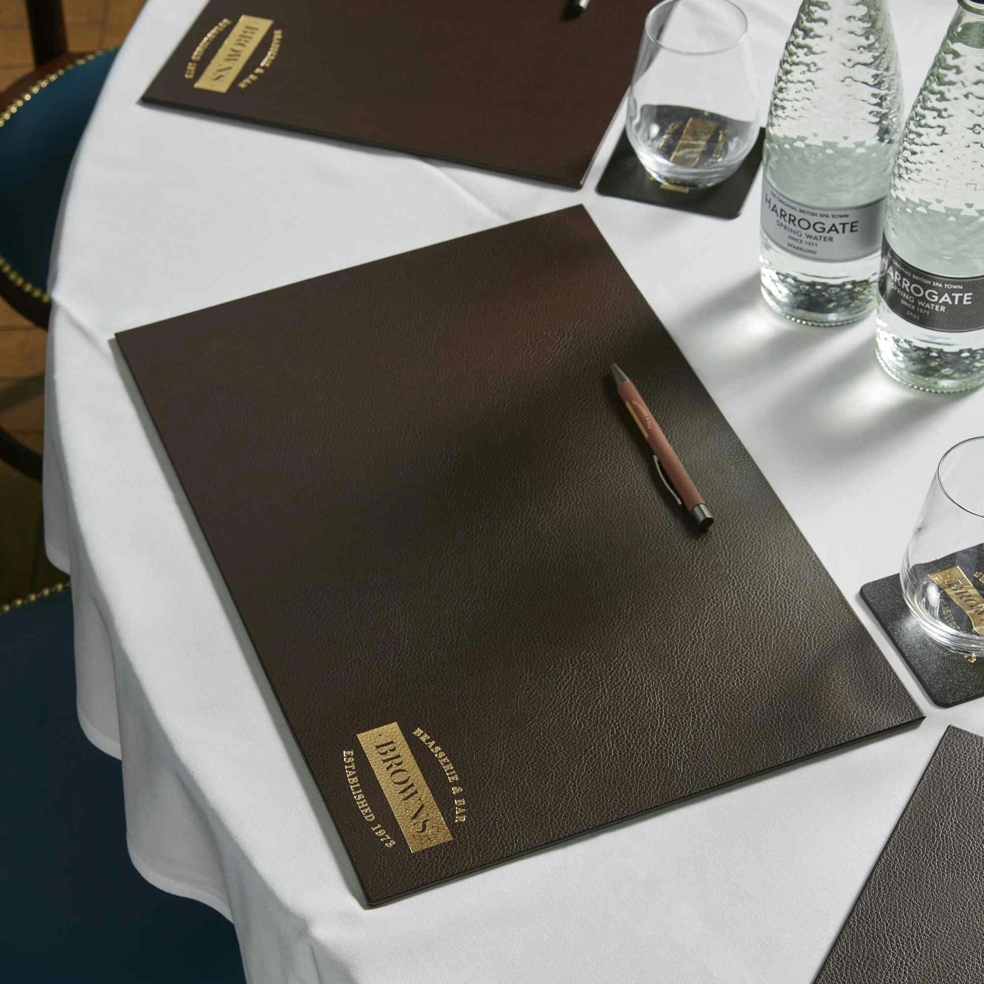 Judge's Chambers meeting setup with leather folder, ideal for upscale events.