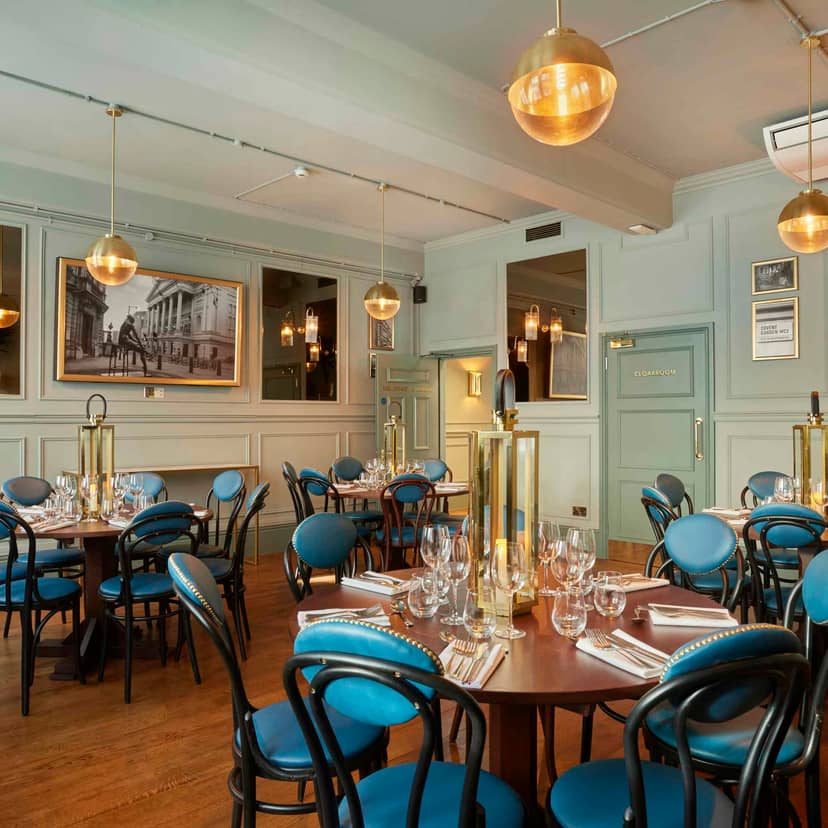 Judge's Chambers dining space with blue chairs, perfect for corporate events and gatherings.