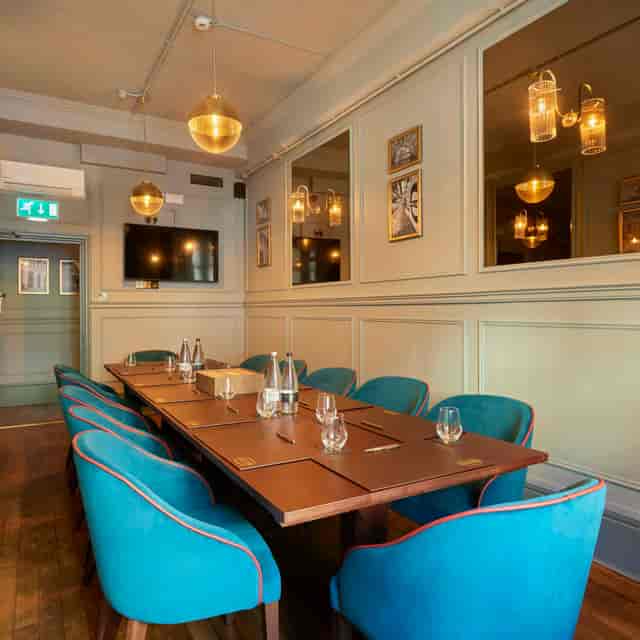 Stylish meeting space in Covent Garden with blue chairs, perfect for corporate events.