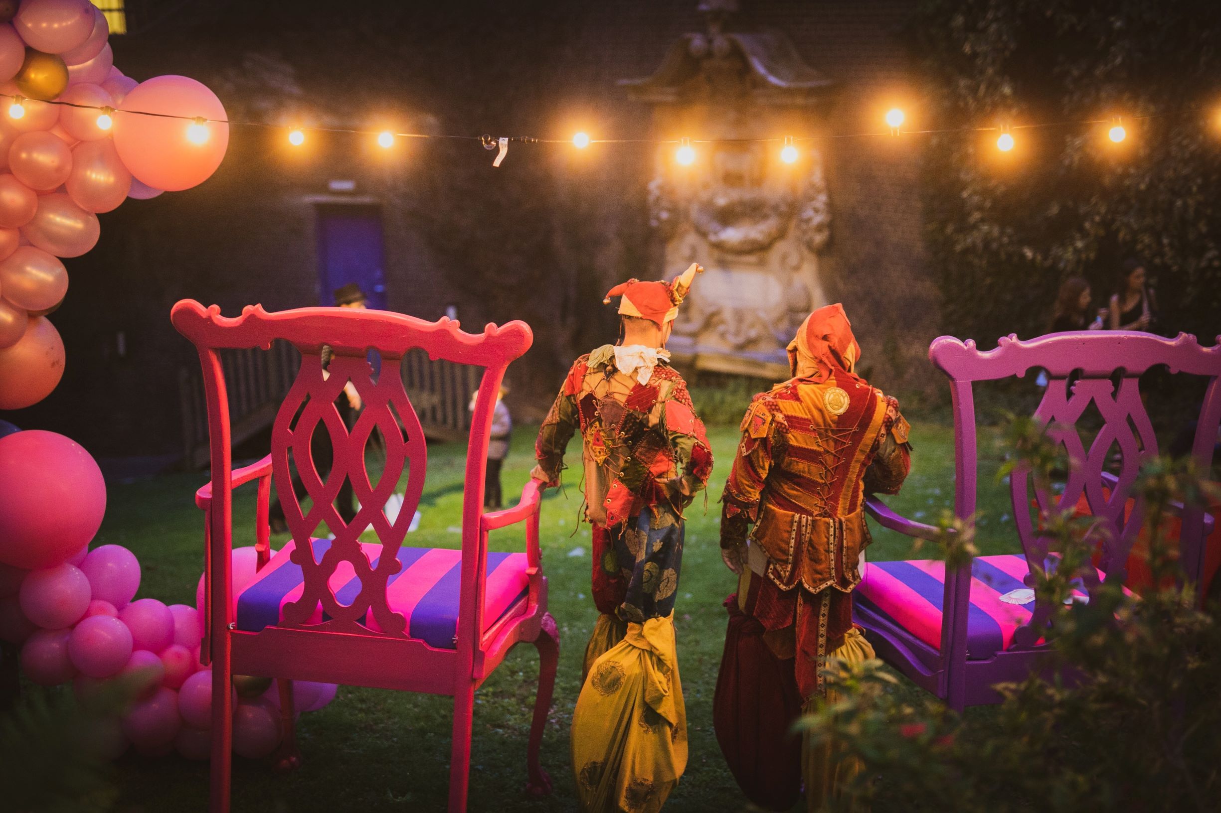 Whimsical outdoor event setup with pink chairs at London Museum Spaces.