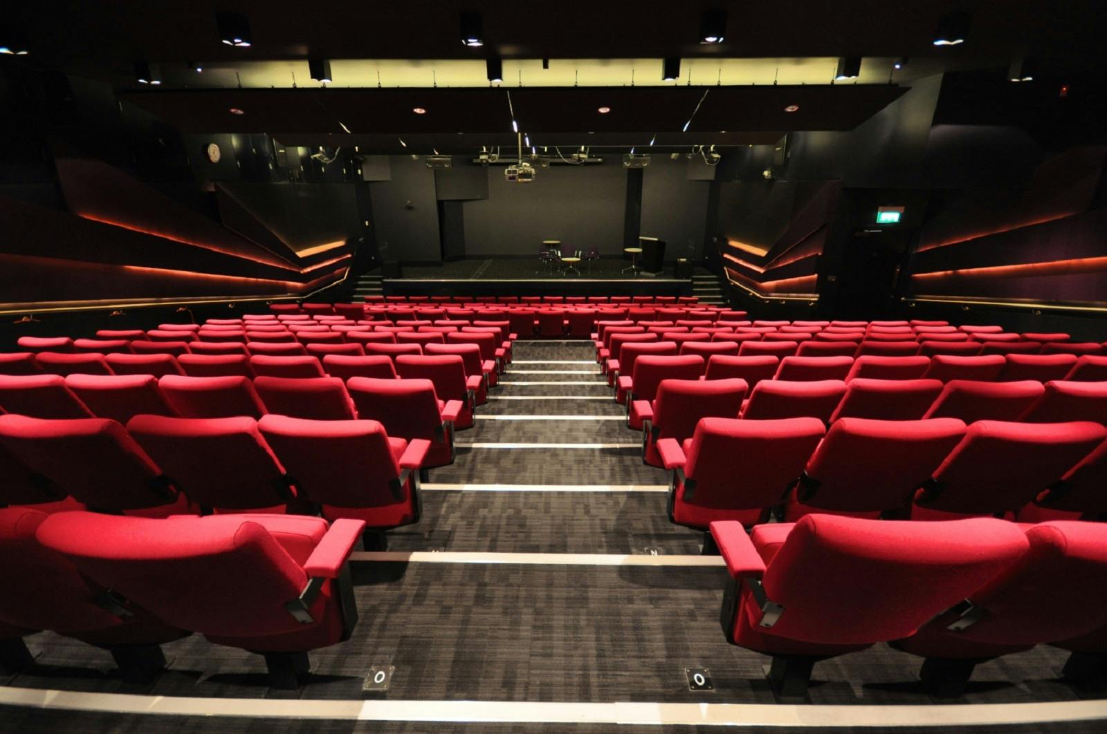 Weston Theatre auditorium with red seating, perfect for corporate events and performances.