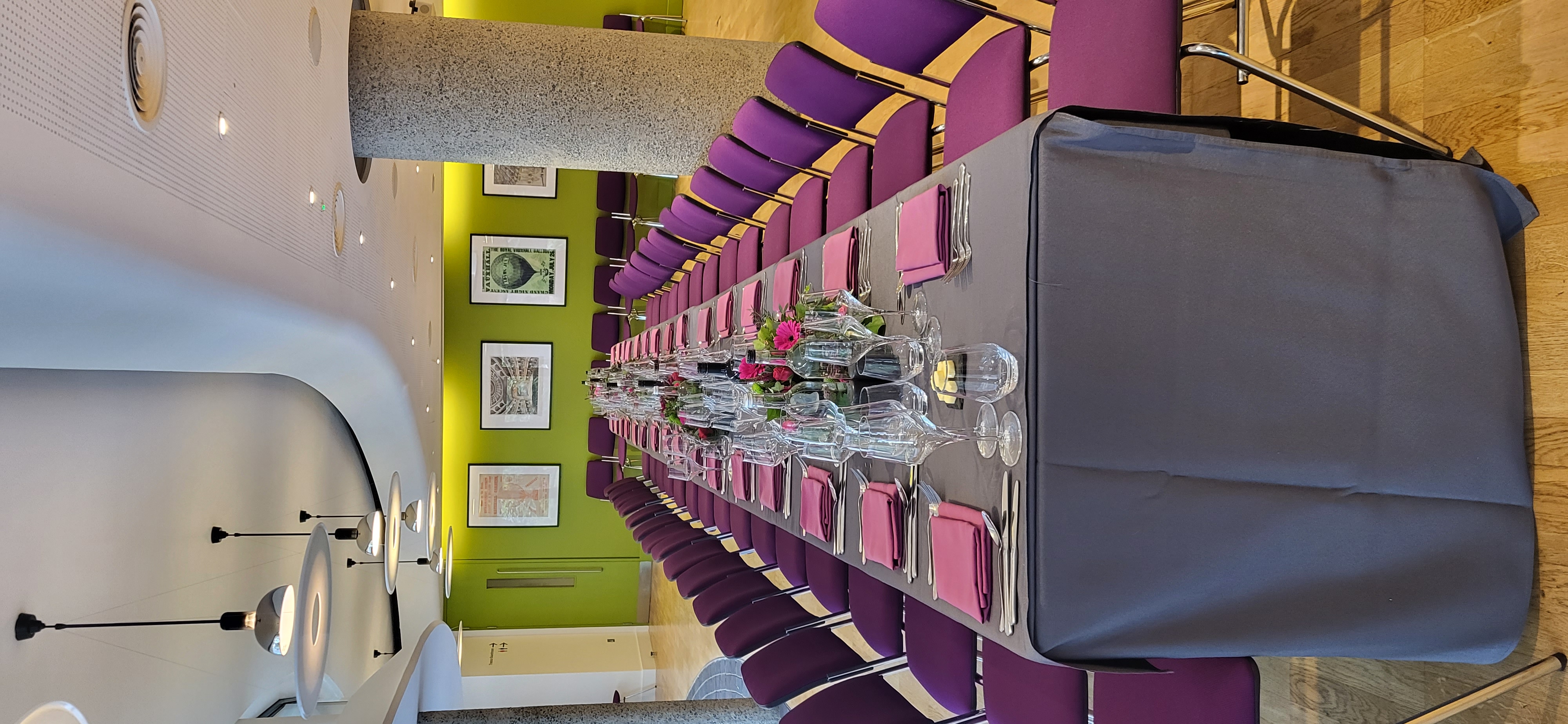 Elegant dining setup with purple chairs at Terrace Gallery, ideal for corporate events. - Banner