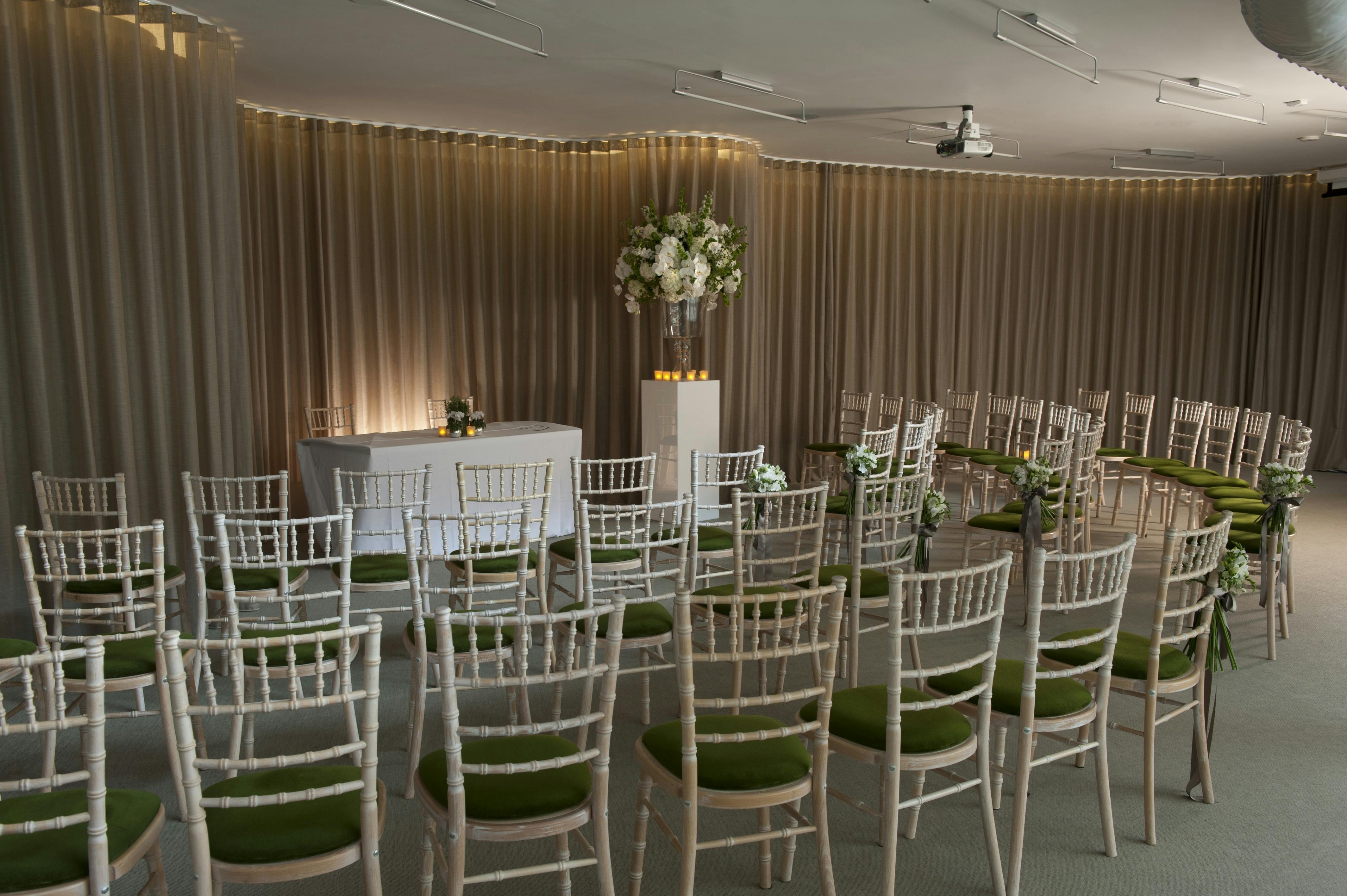 Garden Room at London Museum: elegant chairs, floral decor for meetings and ceremonies.