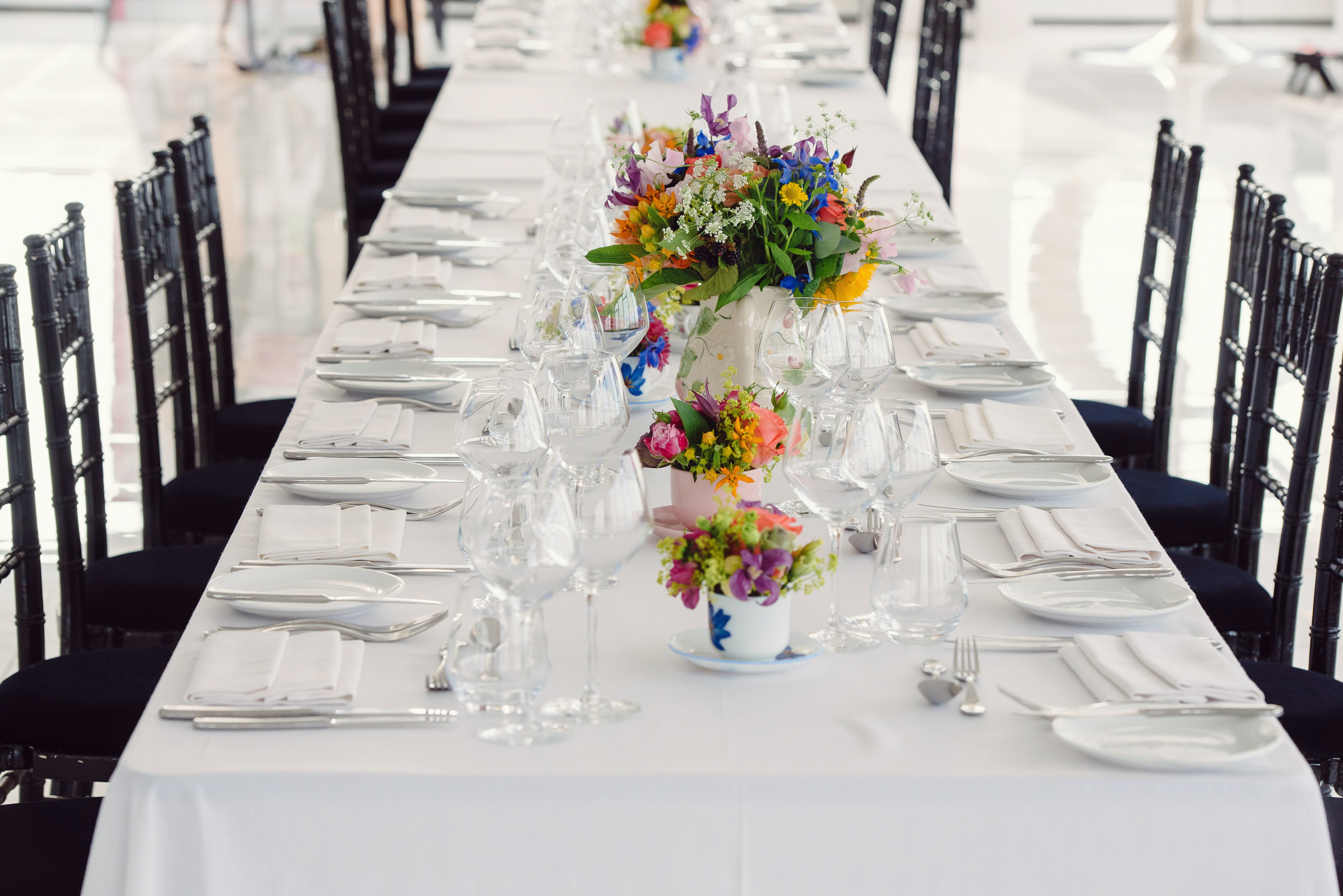 Elegant dining table setup with floral centerpieces for a formal wedding in Altitude London.