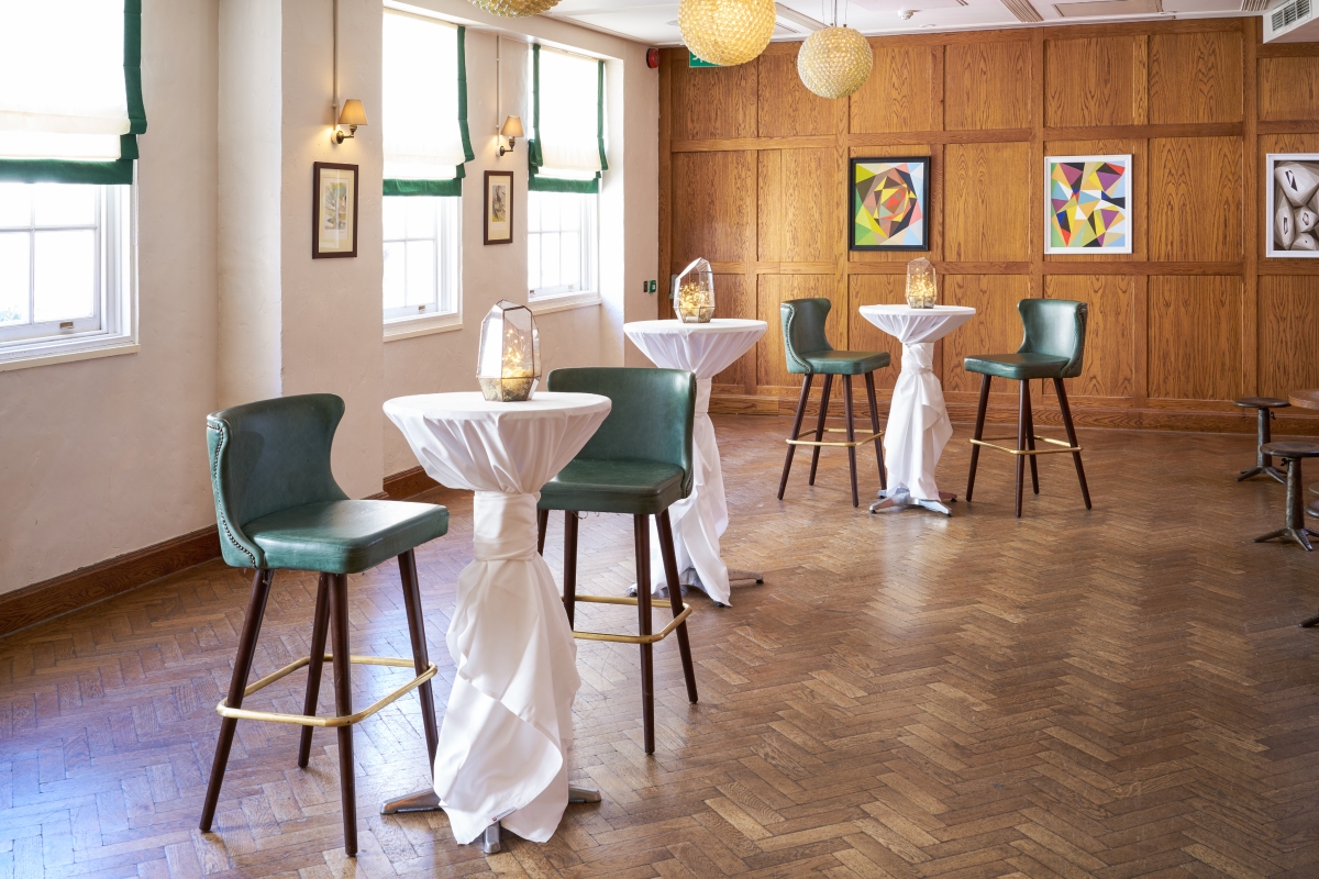 Stylish event space in The Sir Roger Moore Room, ideal for cocktail receptions and networking. - Banner