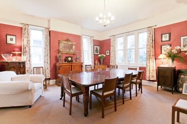 Dining room at St Matthew's Conference Centre with wooden table, ideal for workshops and meetings.