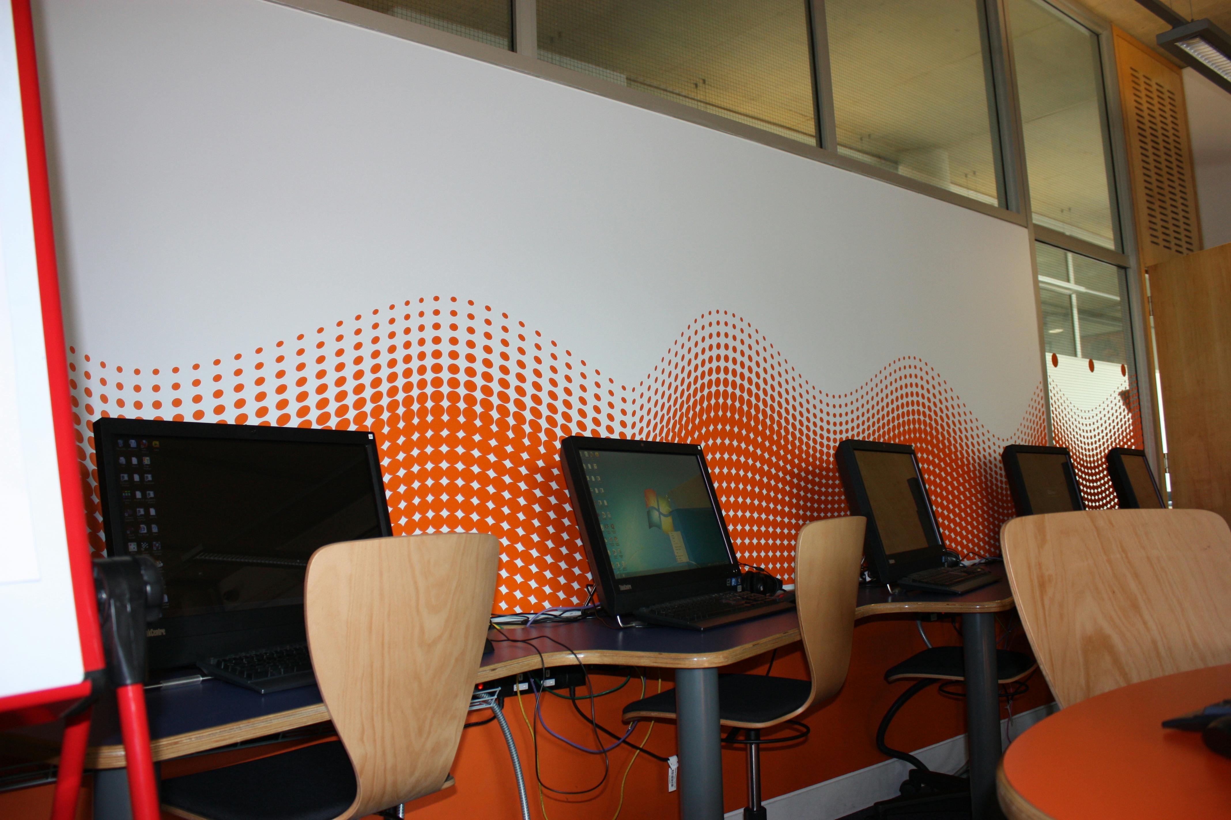 Modern training room with computer stations for tech workshops in Camden City Learning Centre.