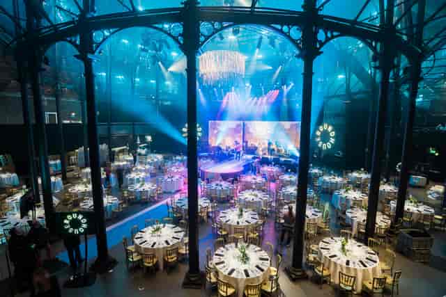Elegant event space in Roundhouse with round tables, perfect for conferences and gala dinners.