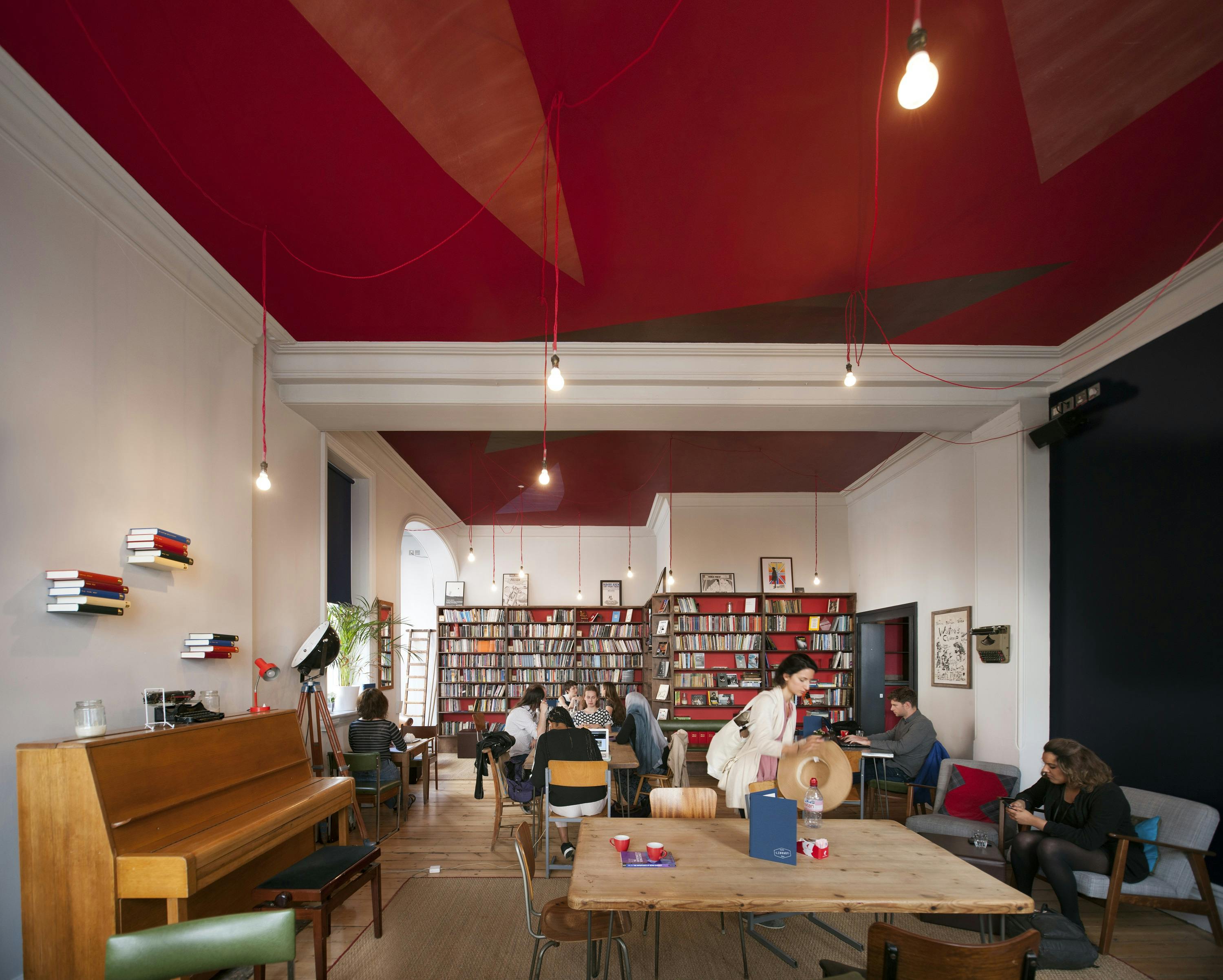 Library in Bush Theatre with red ceiling, ideal for creative meetings and workshops.