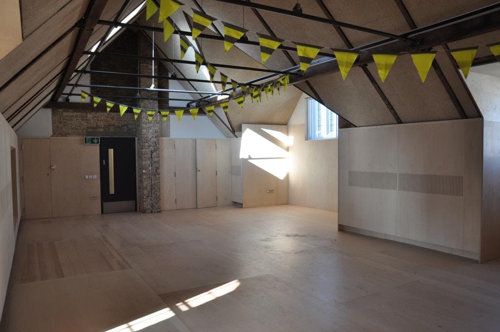 Attic event space at Bush Theatre with high ceilings, ideal for workshops and gatherings.