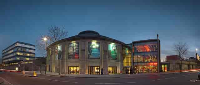 Modern Roundhouse event venue with large glass windows, ideal for conferences and gatherings.