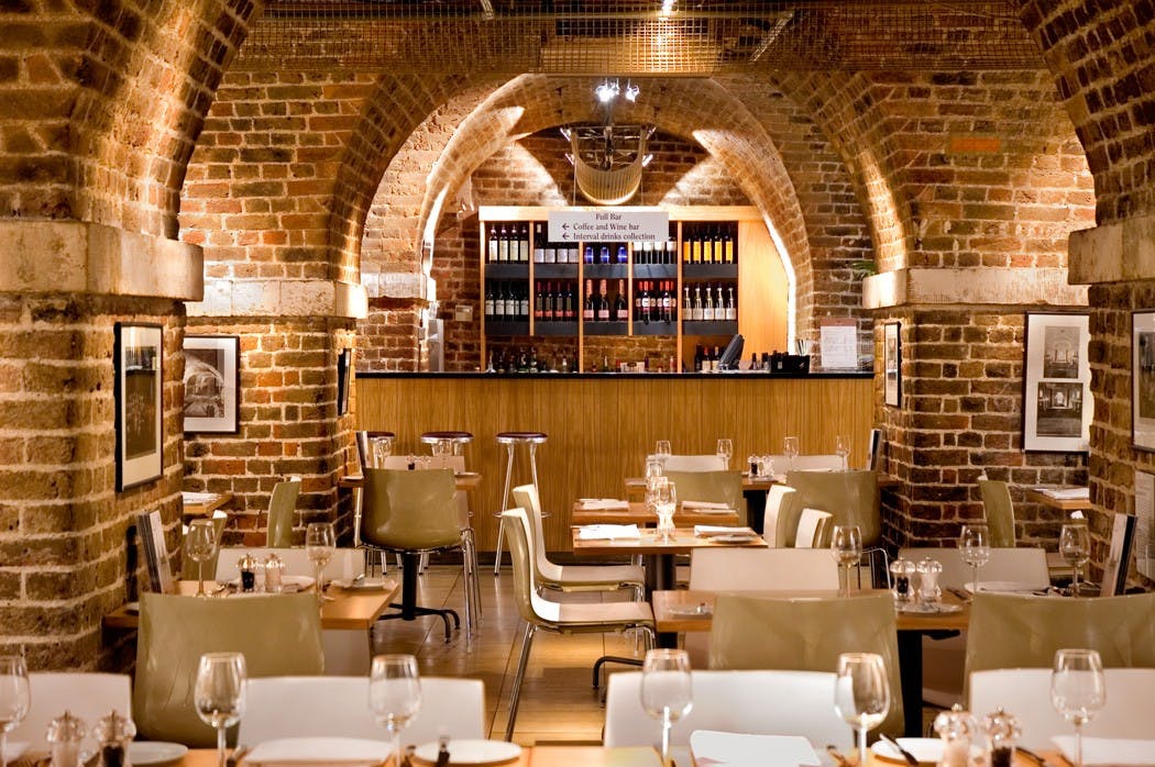 Stylish restaurant with exposed brick arches, ideal for networking events and private dinners.