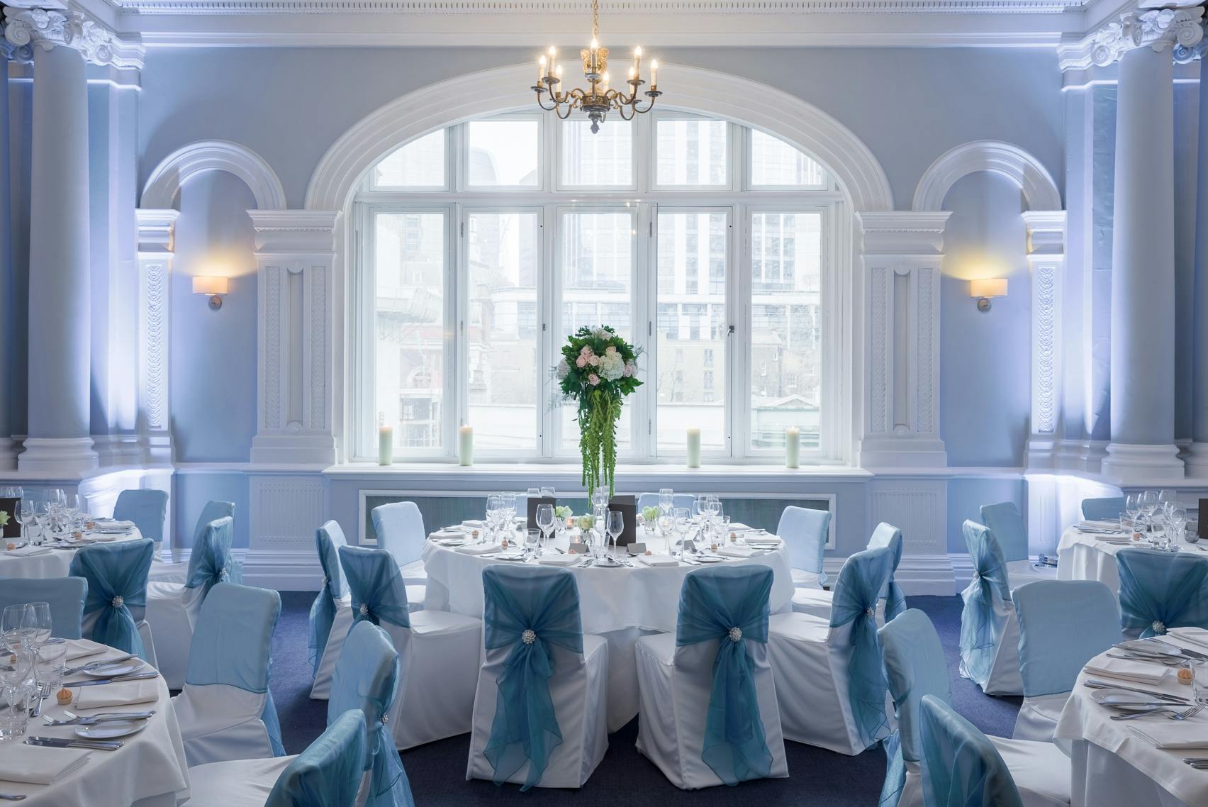 Elegant Fenchurch Suite banquet room with floral centerpiece for weddings and corporate events.