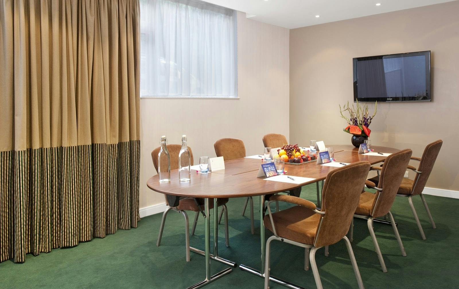 Green Room at K West Hotel: stylish meeting space with round table for small gatherings.