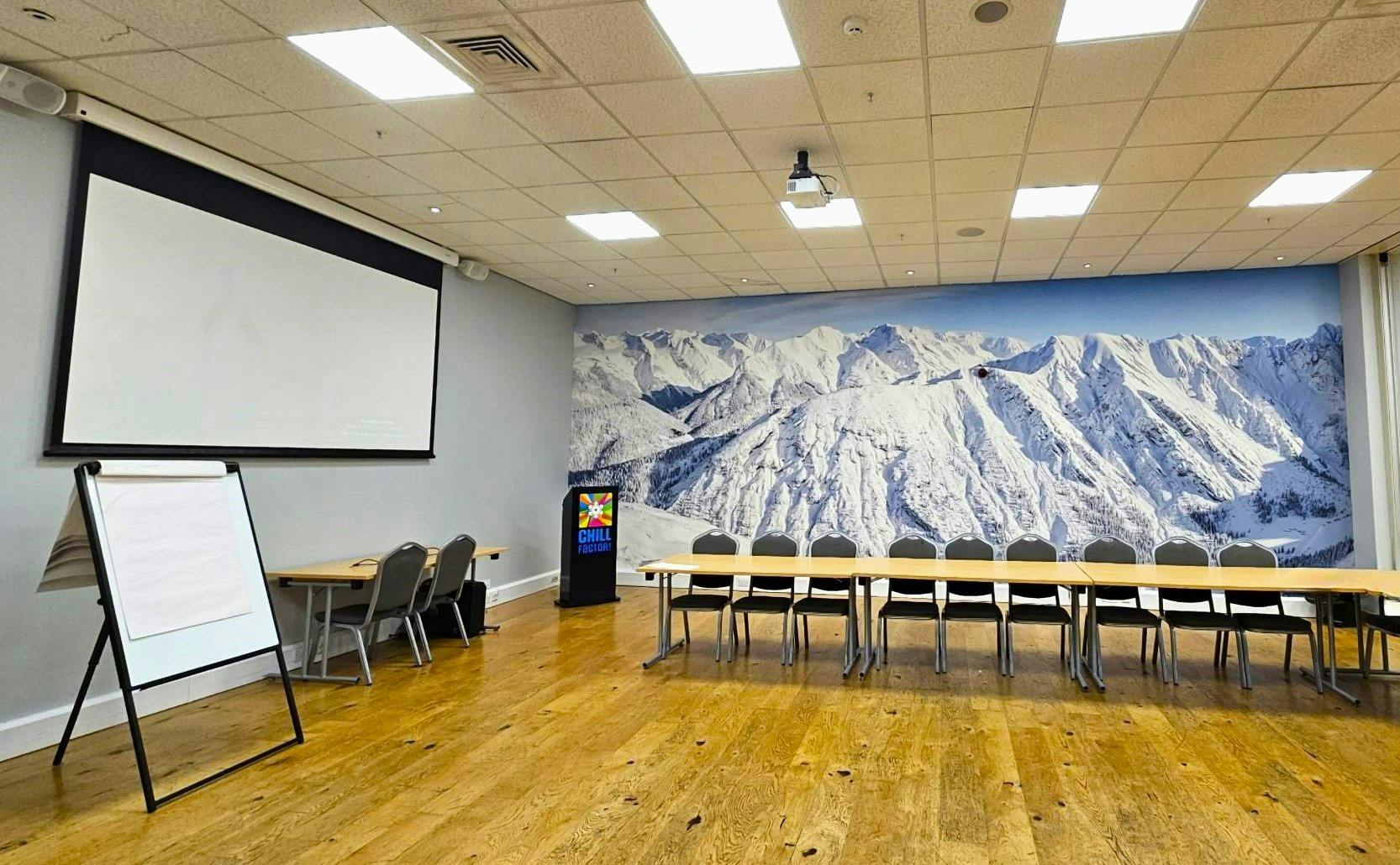 Anton & Aspen Suite meeting room with projection screen, ideal for workshops and meetings.