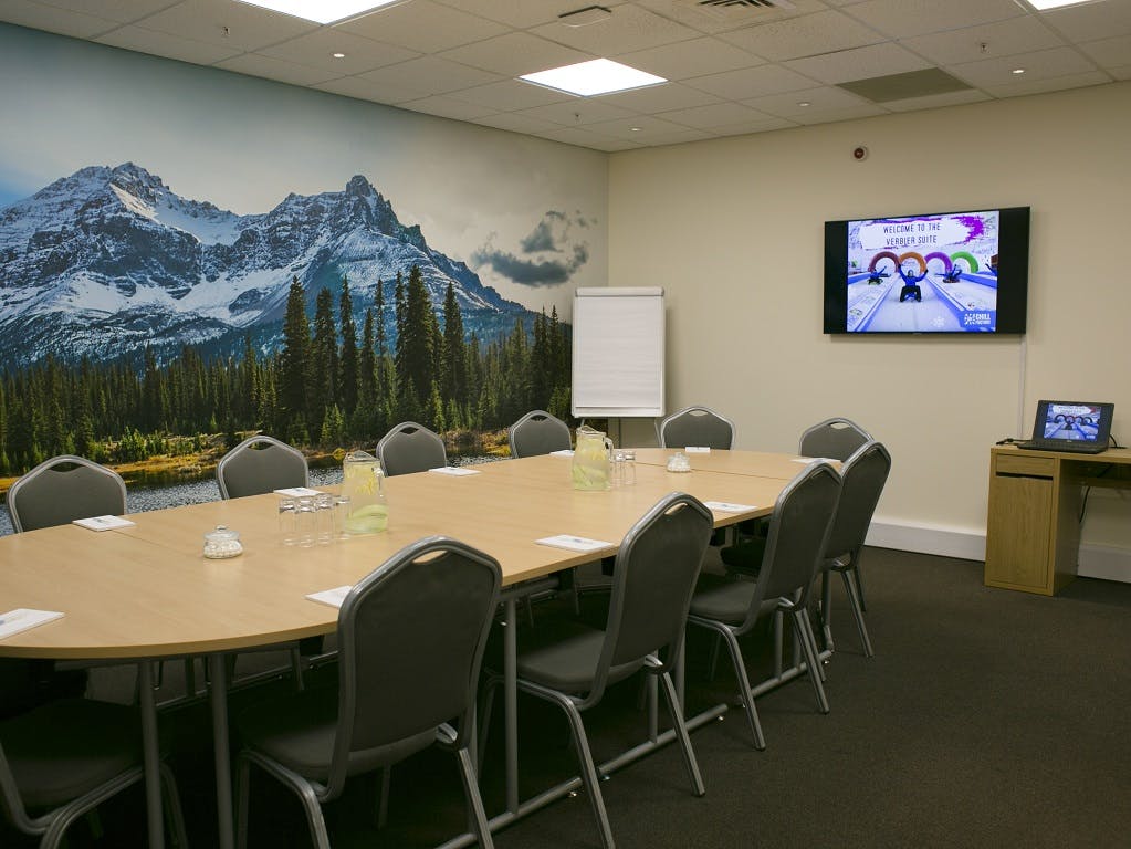 Vail Suite meeting room with oval table, ideal for professional events and gatherings.