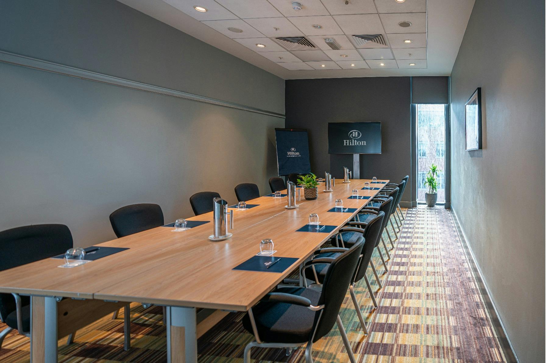 Boardroom at Hilton Deansgate, ideal for corporate meetings and presentations.