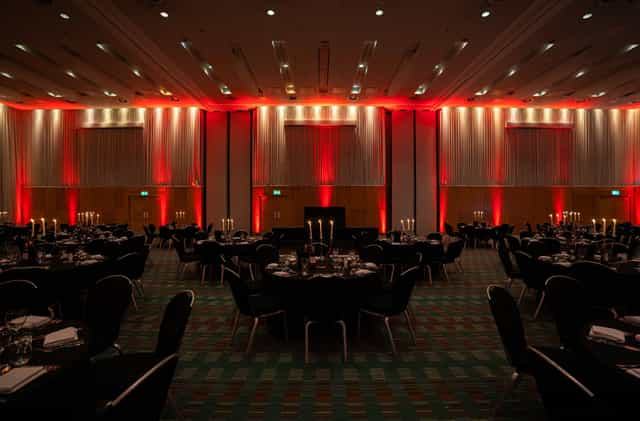 Deansgate Suite at Hilton: elegant dinner setup with black linens and warm lighting.