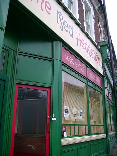 Quaint veggie café with vibrant green exterior, ideal for networking events and meetings.