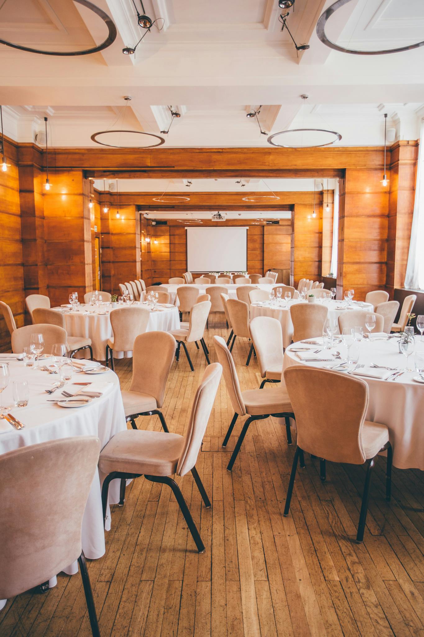 Elegant Bethnal Hall event space with round tables, ideal for corporate meetings and banquets.