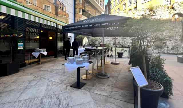 Outdoor event setup at Leonardo Royal Hotel, featuring a black umbrella and elegant buffet.