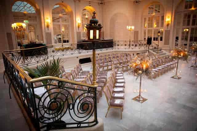 Elegant wedding setup in Palm Court, Waldorf Hilton, featuring floral centerpieces.