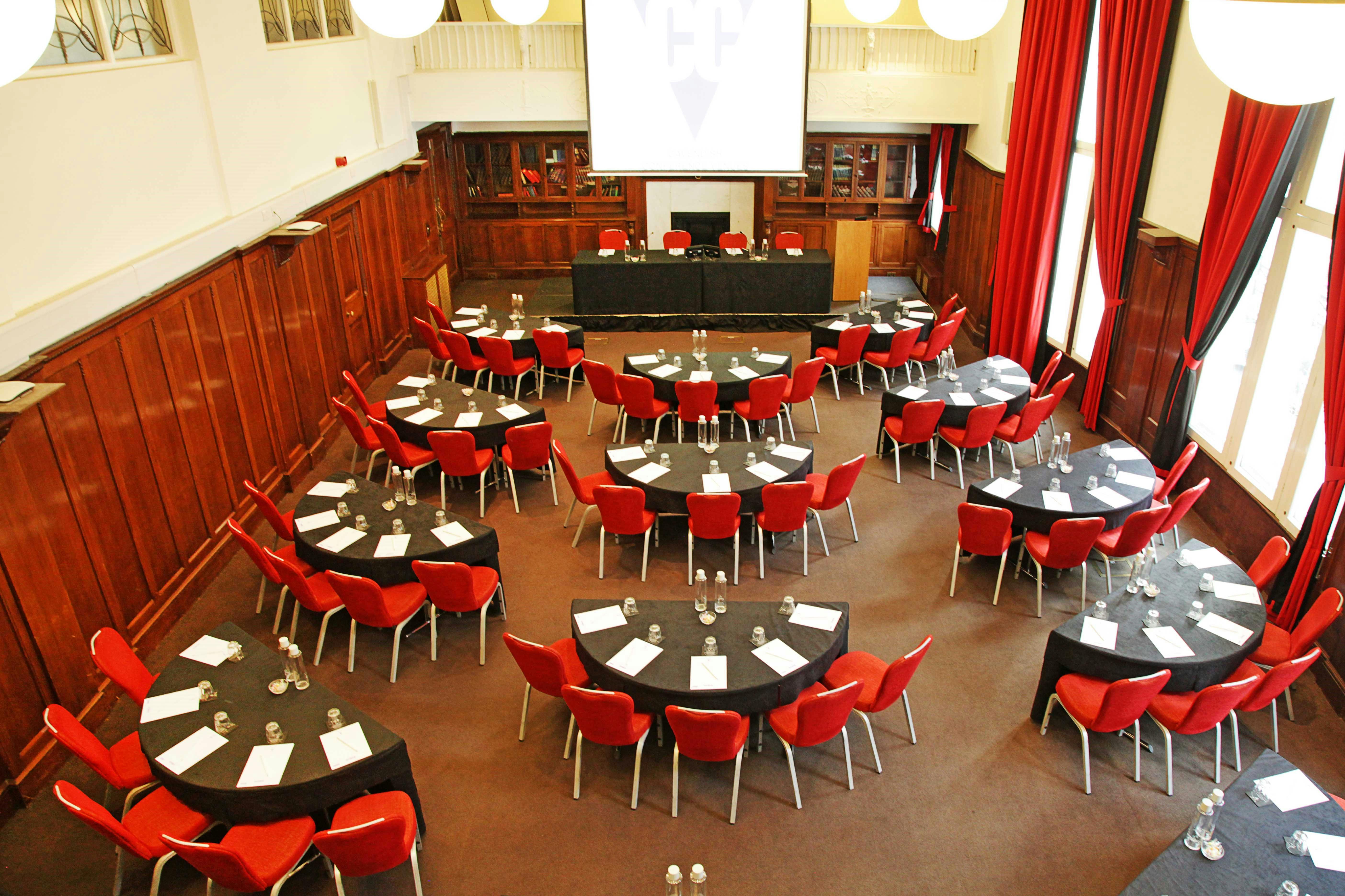 Council Chamber at Hallam Conference Centre with round tables for professional meetings.