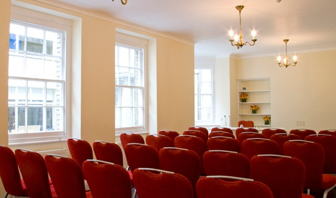 Baker Suite meeting room with red chairs, ideal for conferences and workshops.