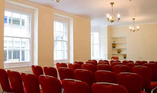 Baker Suite meeting room with red chairs, ideal for conferences and workshops.