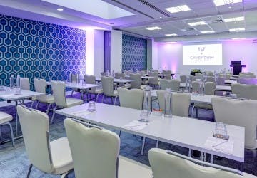 Modern conference room with tables and chairs for corporate workshops in America Square.