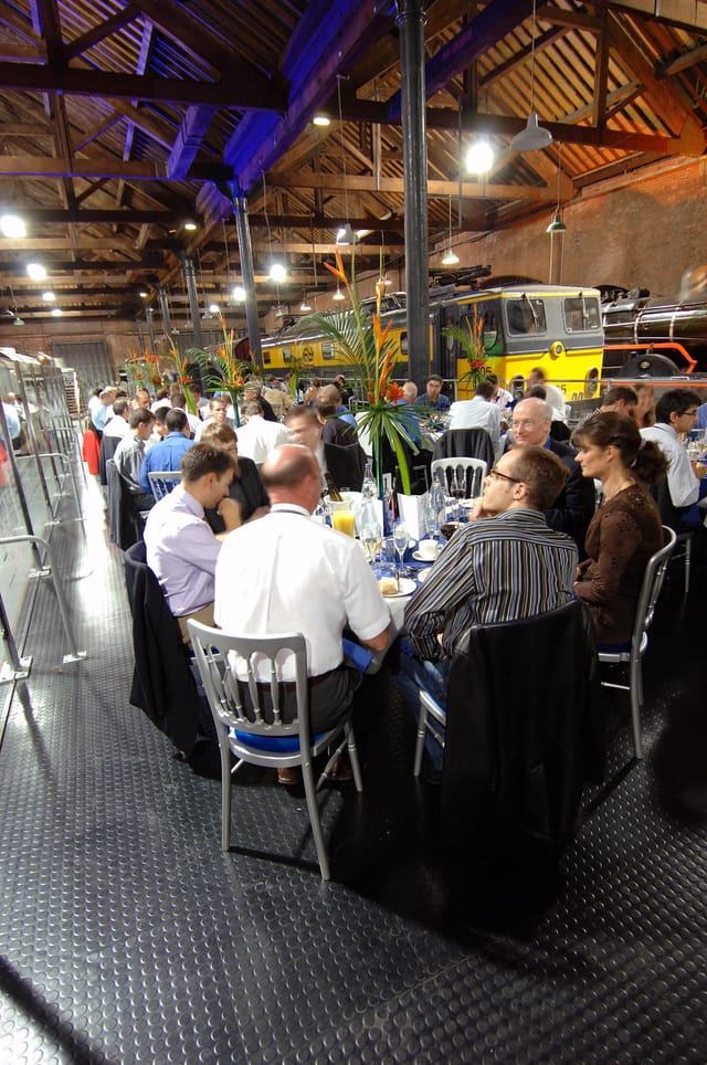 Power Hall event setup with vintage trains, greenery for networking and engagement.
