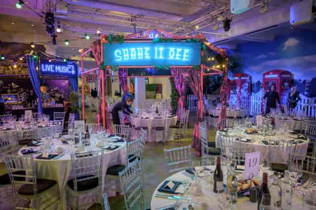 Vibrant party setup at Madame Tussauds with colorful stage and elegant tables.
