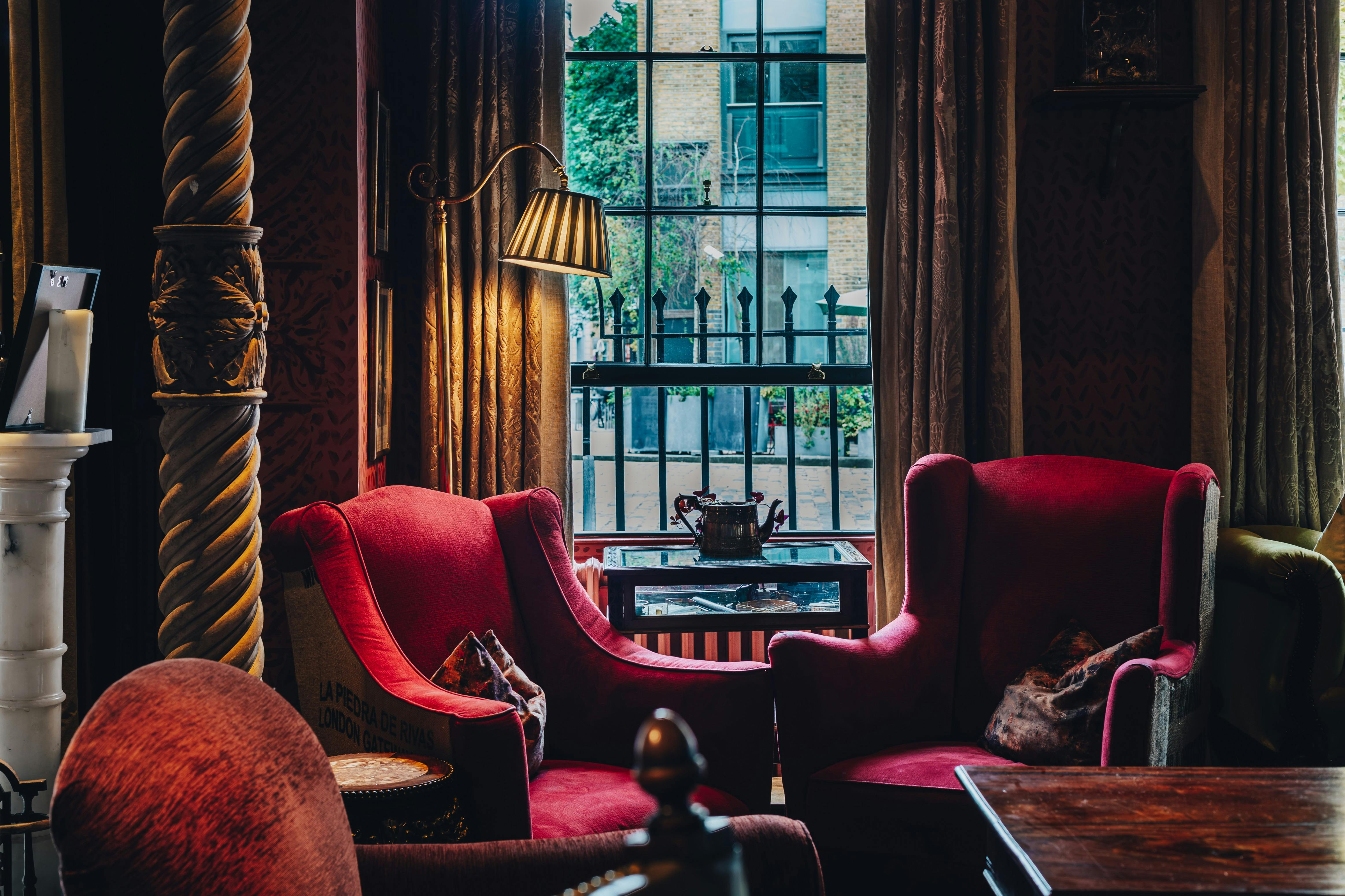 Cozy meeting space with plush red armchairs at The Zetter Clerkenwell for gatherings.