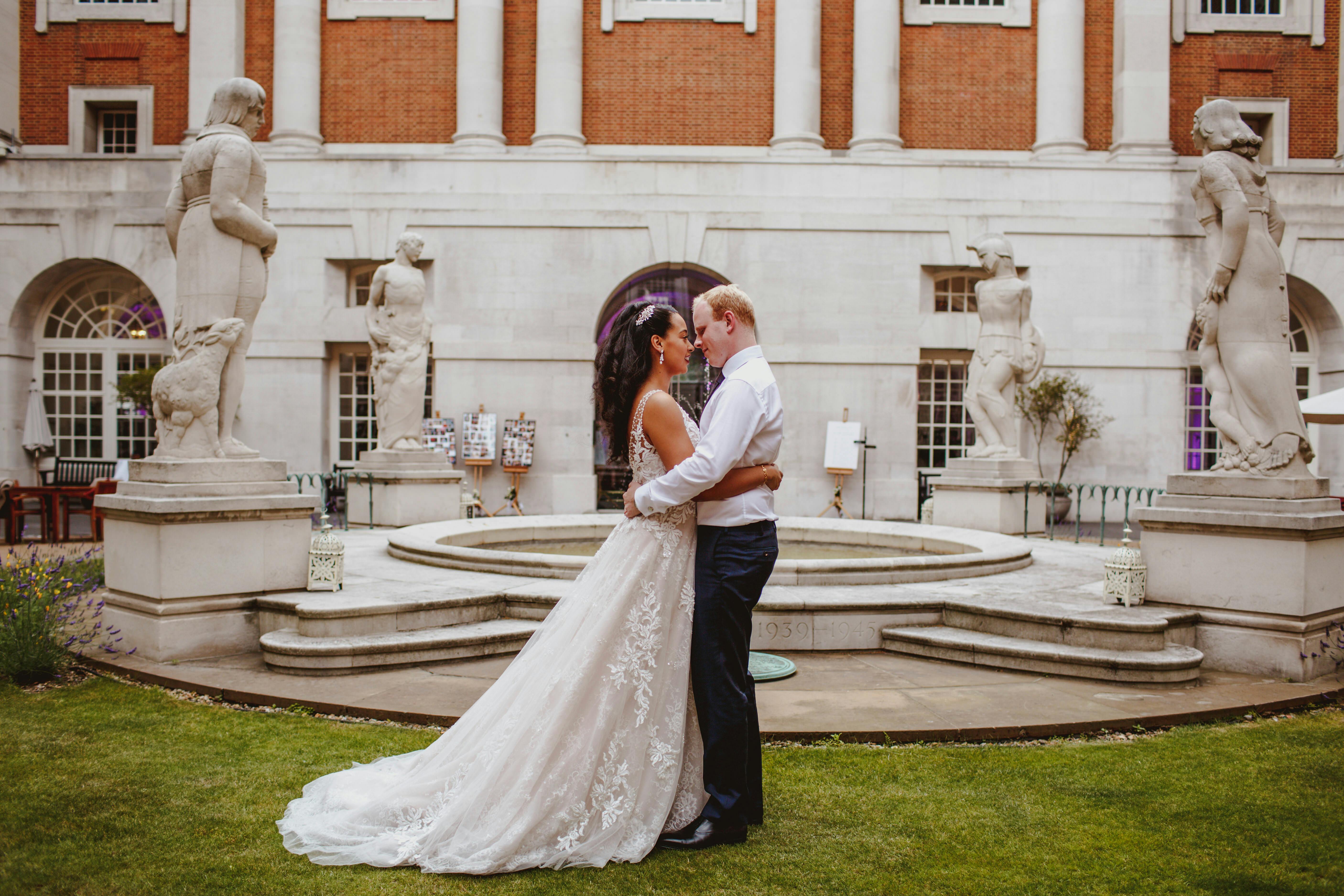 Romantic outdoor wedding at BMA House courtyard with couple by decorative fountain.