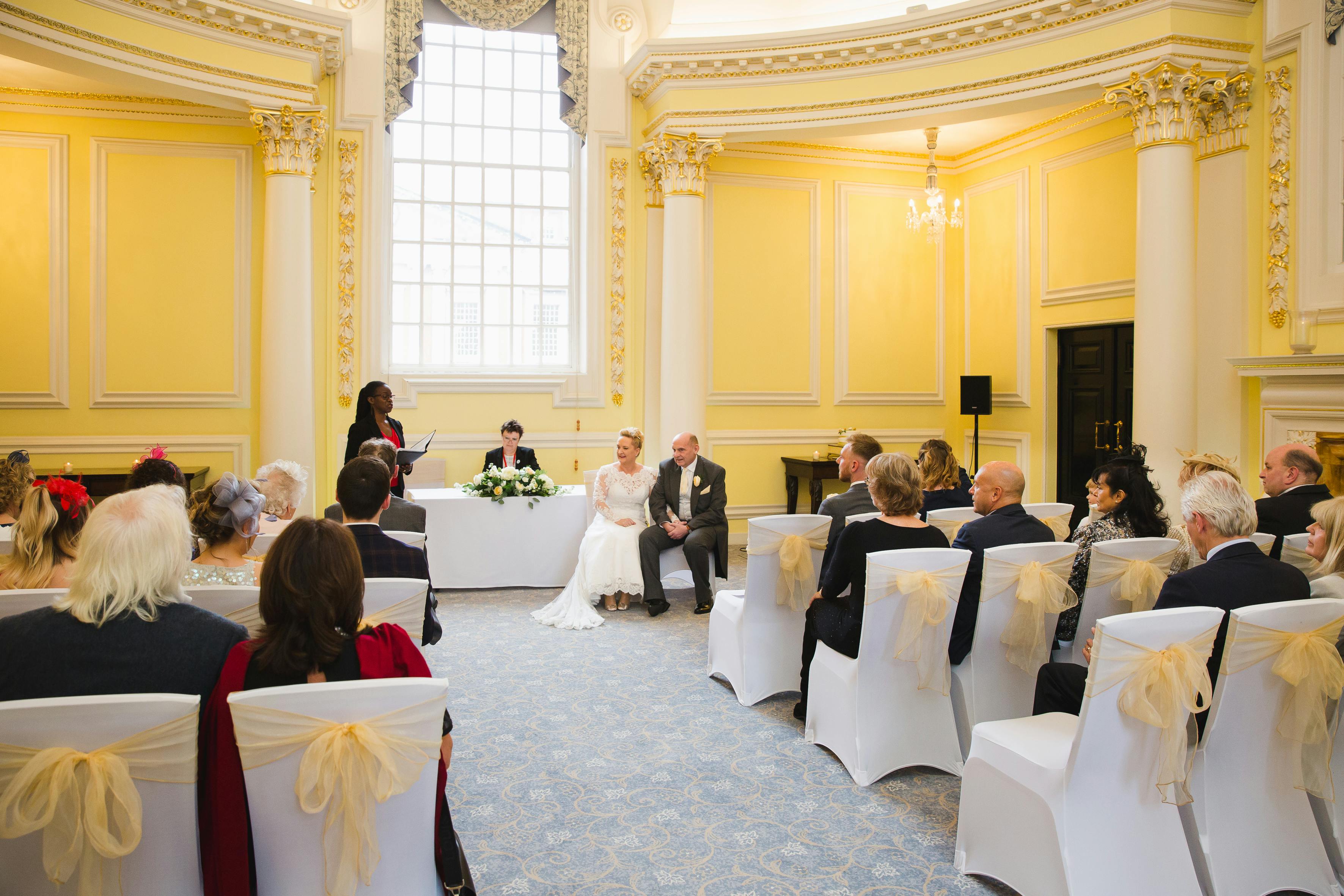 Elegant wedding ceremony in Prince's Room, BMA House with bright yellow walls.