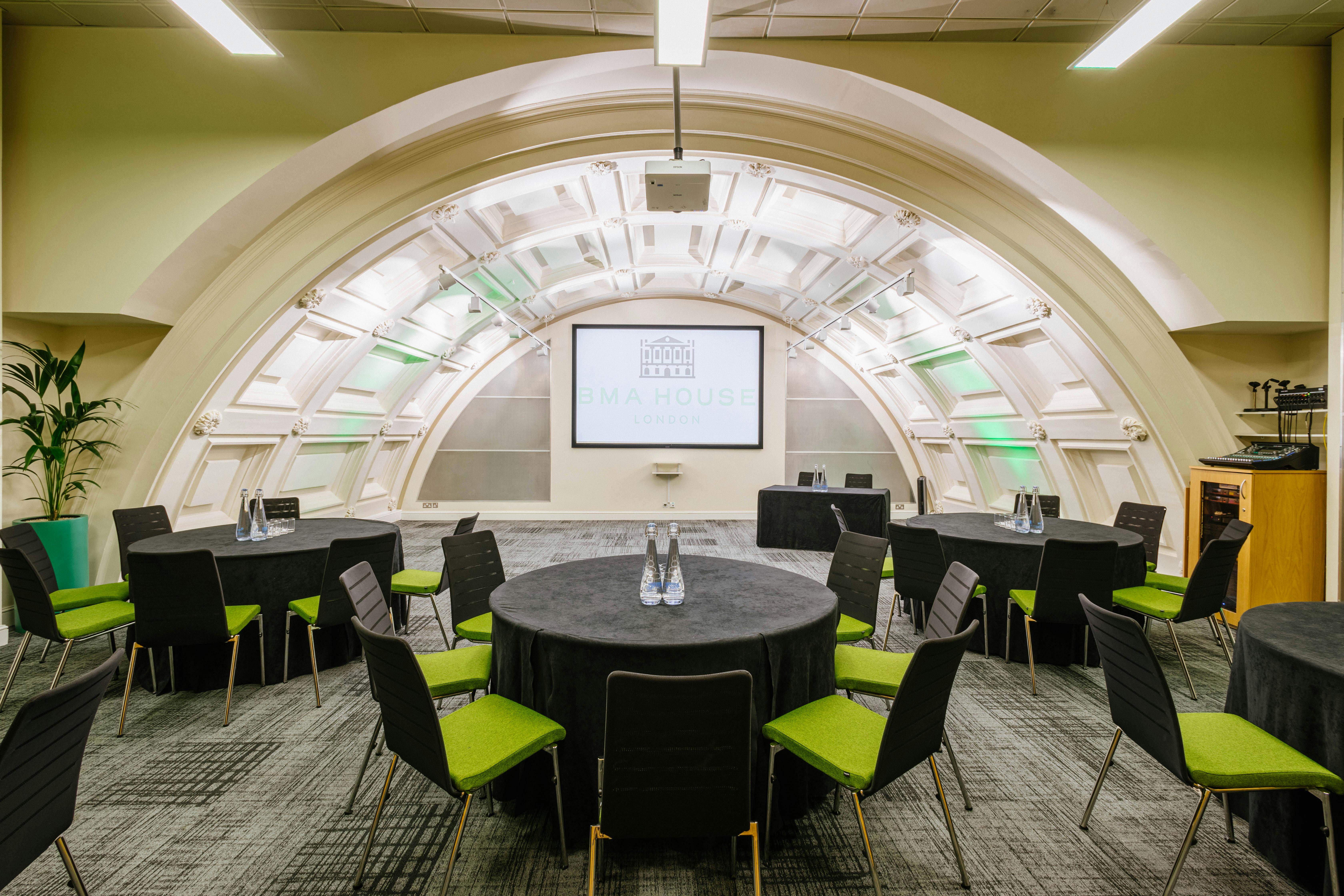 Modern meeting space in BMA House with round tables for workshops and presentations.