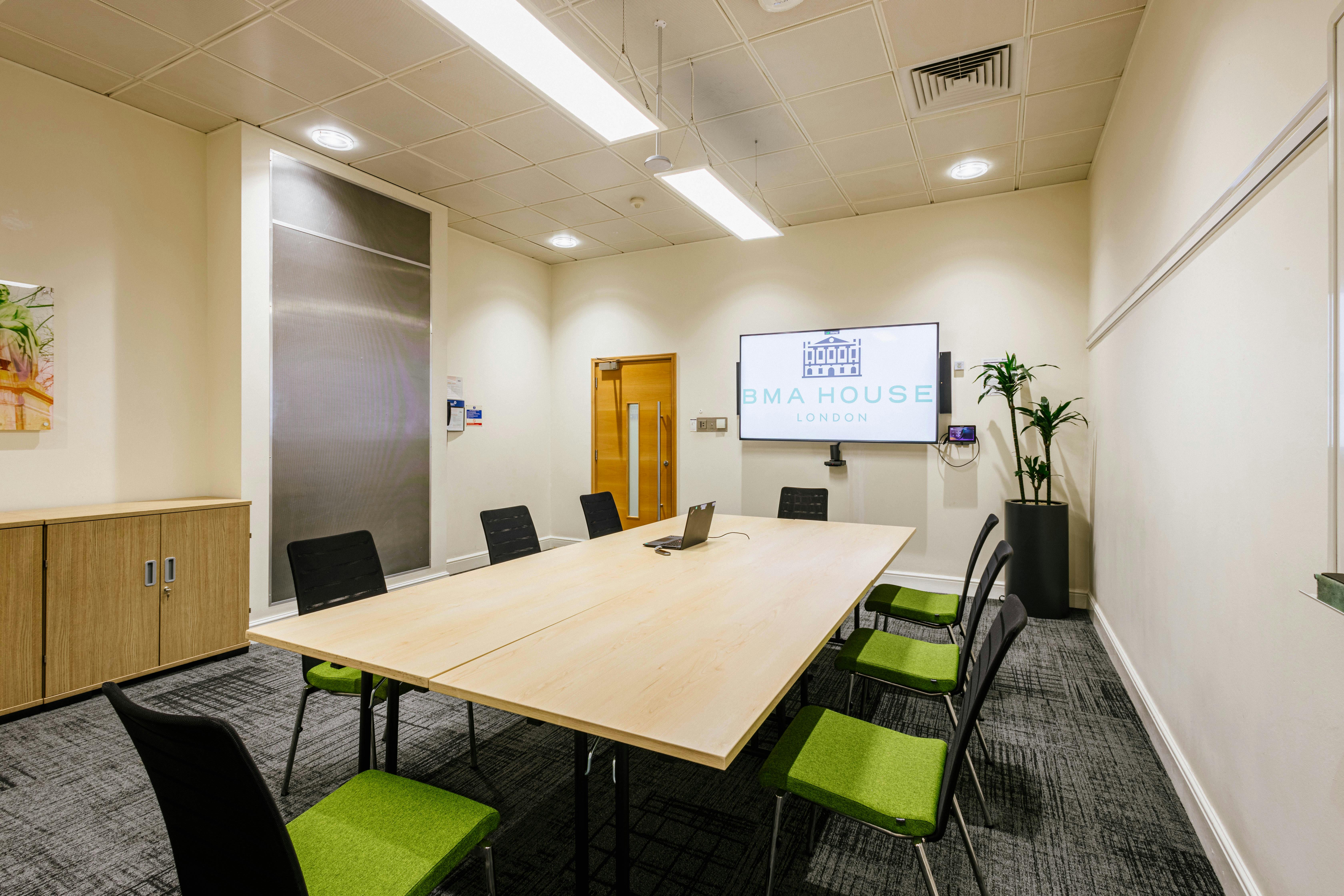 Modern Simpson Room at BMA House with large table for meetings and presentations.