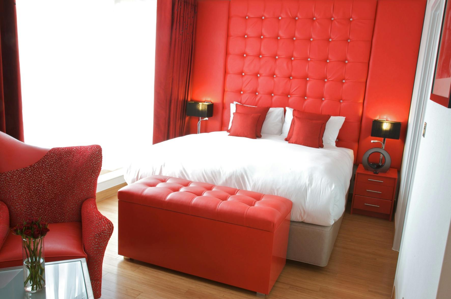 Ruby Loft Suite at Bermondsey Square Hotel, vibrant red decor for meetings and events.