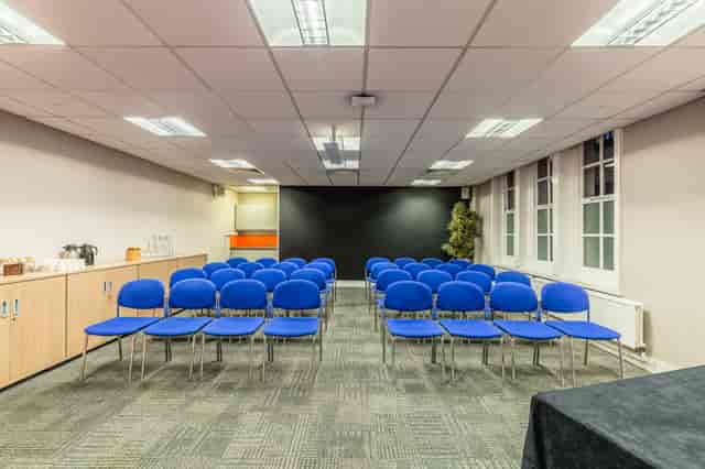 Dickens Room at BMA House: organized meeting space with blue chairs for workshops and seminars.