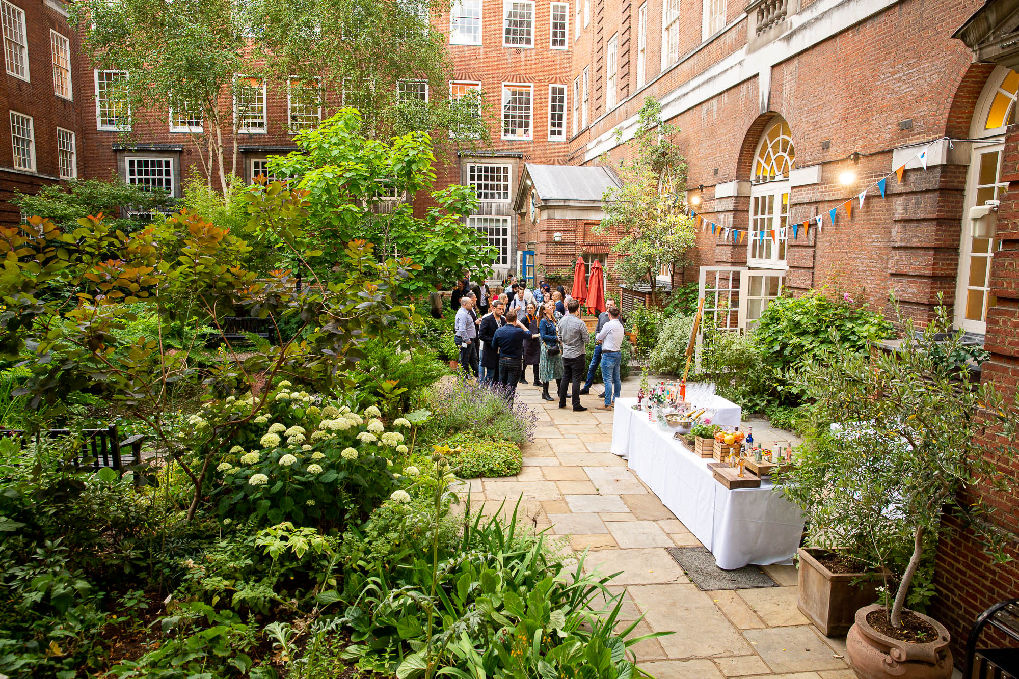 Vibrant outdoor event space with lush greenery for networking and social gatherings.