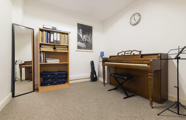 Cozy Small Music Room with piano for creative meetings and team-building activities.
