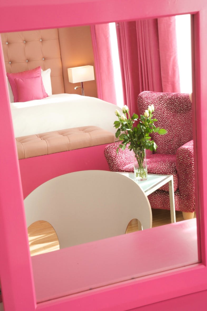 Jude Loft Suite at Bermondsey Square Hotel, vibrant pink meeting space for brainstorming sessions.