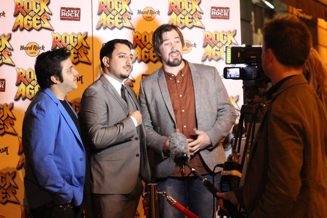 Red carpet event at Hard Rock Manchester with vibrant branding and media engagement.