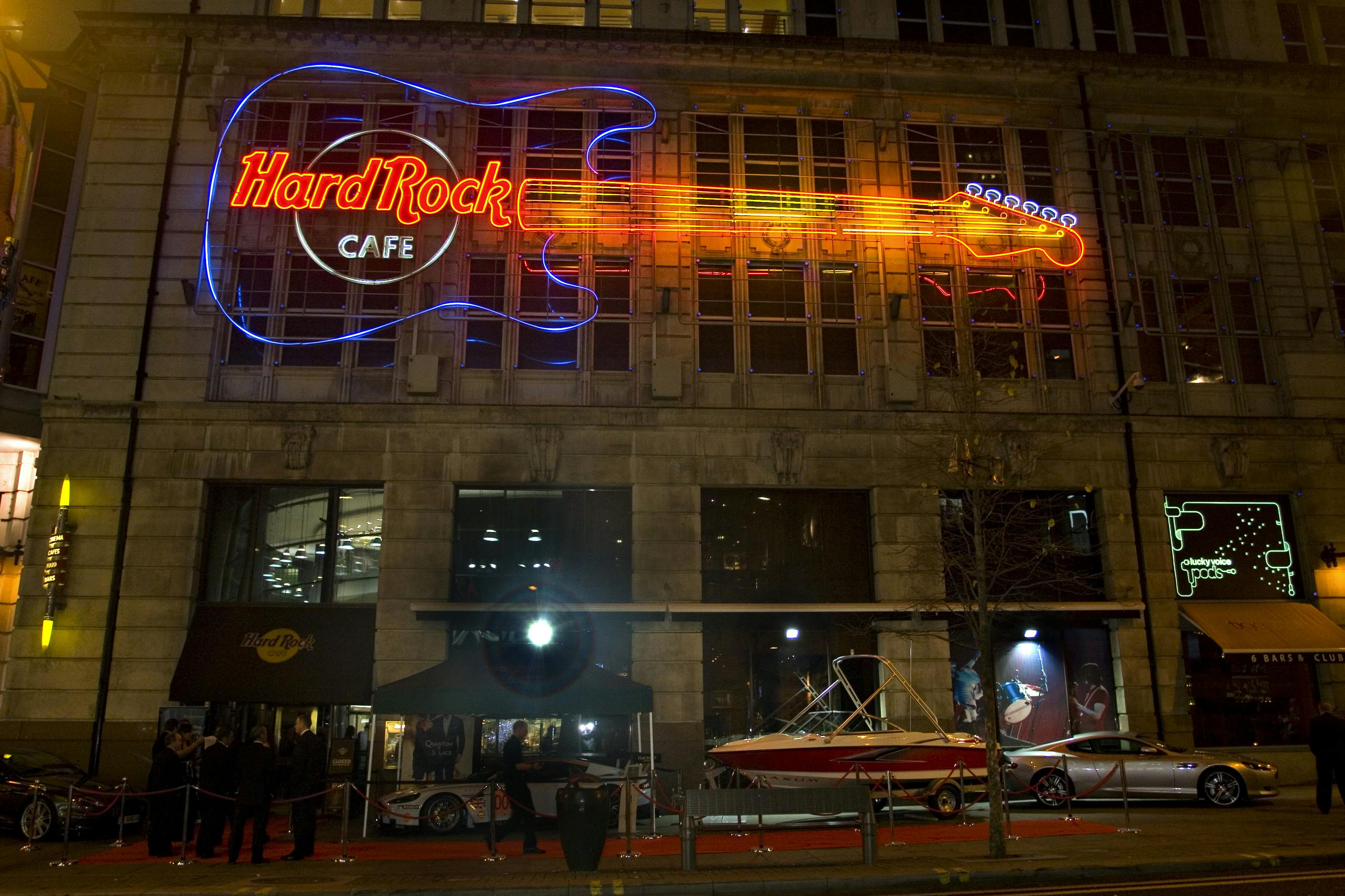Hard Rock Cafe Manchester exterior with neon guitar sign, perfect for events and gatherings.