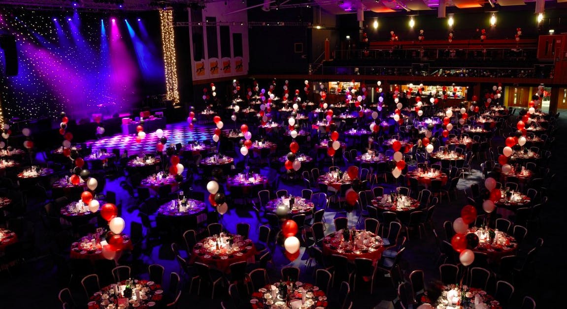 Elegant event space at Cheltenham Racecourse with red and white balloons for galas.