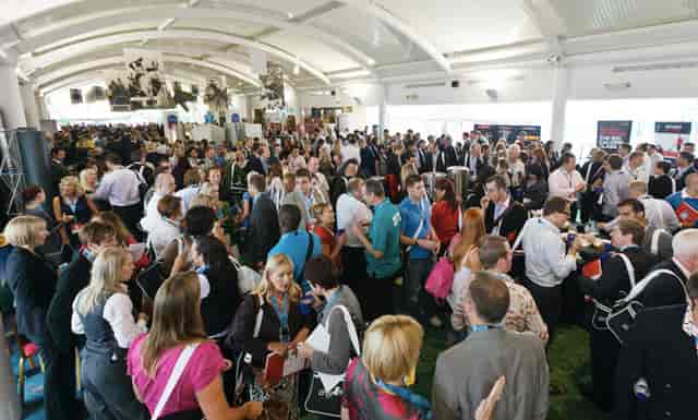 Hall of Fame at Cheltenham Racecourse, vibrant networking event with diverse attendees.