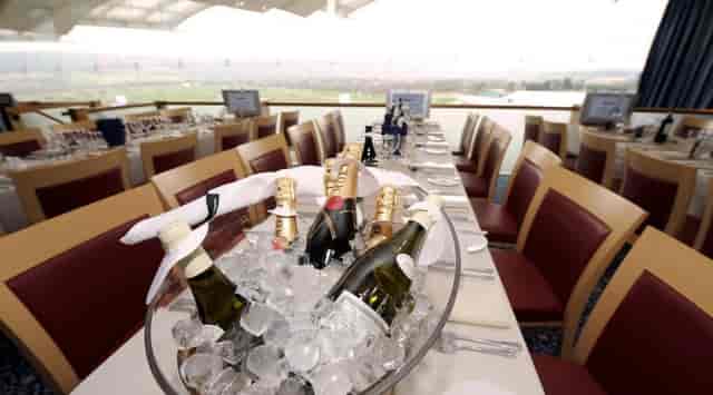 Elegant dining table with champagne at Cheltenham Racecourse for corporate events.